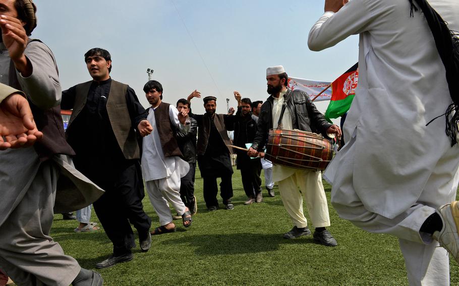 Afghan men dance to a drum at a rally for presidential candidate Ashraf Ghani in Kabul on April 1, 2014. Joyful rallies took place against the background of a rash of terrorist attacks in the run-up to the poll.