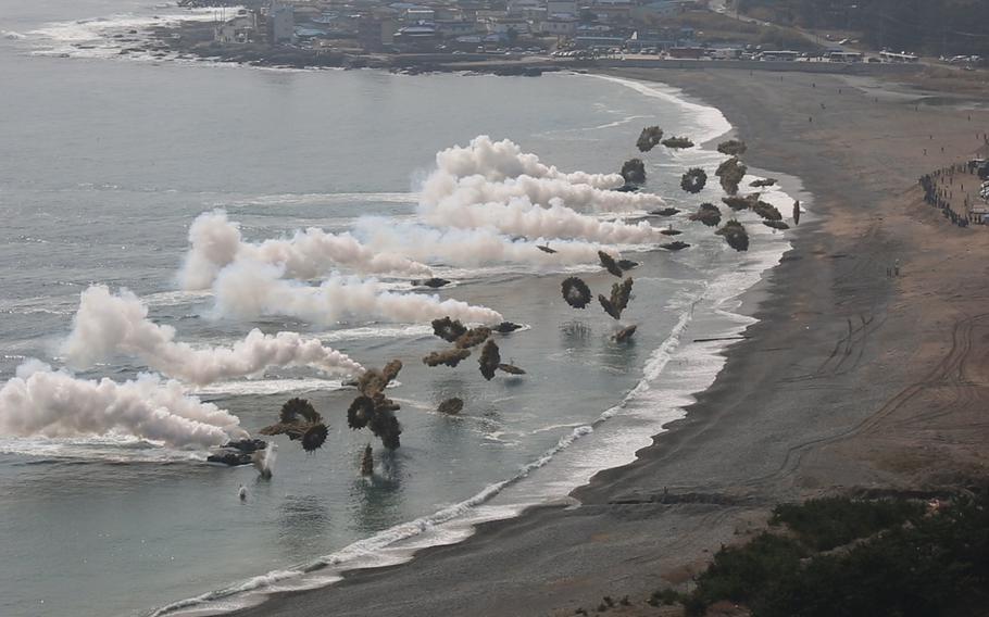 South Korean and U.S. Marine amphibious assault vehicles deploy smoke grenades before storming the shoreline during the amphibious assault portion of exercise Ssang Yong 2014 at Dokseok-ri Beach in Pohang, South Korea, on March 31, 2014.