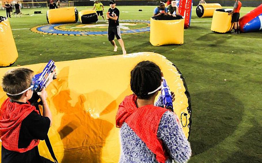 U.S. Marines and kids from the base youth center play a game of Nerf tag at Naval Support Activity Bahrain April 4, 2014.