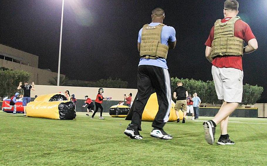 U.S. Marines and kids from the base youth center play a game of NERF tag at Naval Support Activity Bahrain April 4, 2014.