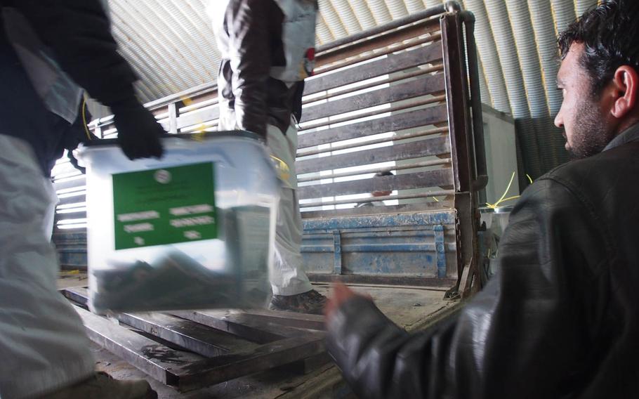 Boxes of ballots are offloaded in a storage hangar at Afghanistan's Independent Election Commission in Kabul on Sunday, April 6, 2014. Despite threats of attacks from the Taliban, Saturday's Afghan presidential election was largely violence-free.