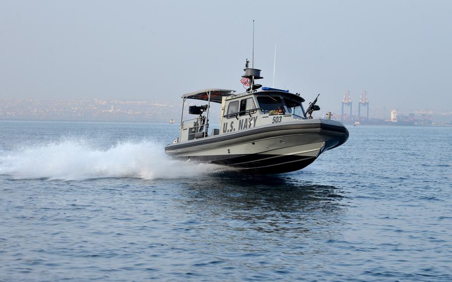 A U.S. Navy vessel of Coastal Riverine Squadron-1 Forward Wave 2 skips across the water while on patrol in Djibouti port. The vessels can reach speeds around 40 knots.