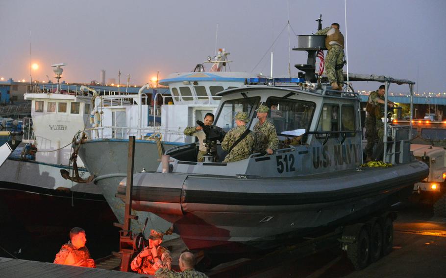 Just before dawn, sailors of the Coastal Riverine Squadron-1 Forward Wave 2 prepare their 34-foot Sea Ark vessels for a patrol of Djibouti harbor.