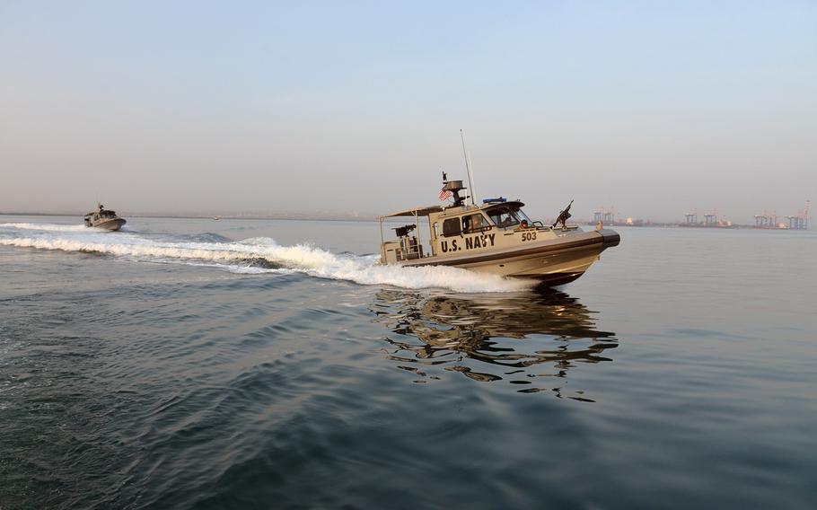 Two U.S. Navy 34-foot Sea Ark vessels of Coastal Riverine Squadron-1 Forward Wave 2 patrol the waters of Djibouti harbor.