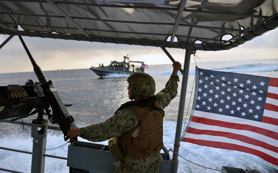Petty Officer 1st Class Cindy Berkshire keeps a lookout during a patrol of Djibouti port with Coastal Riverine Squadron-1 Forward Wave 2. The Navy's Coastal Riverine Squadrons, formed soon after the 2000 terrorist attack on the USS Cole in Yemen, provide security for Navy ships navigating through dangerous waters around the world.