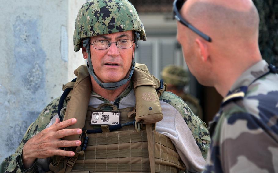 U.S. Coast Guard Cmdr. Alan Tubbs, who leads 69 sailors deployed with Coastal Riverine Squadron-1 Wave 2 to Camp Lemonnier, Djibouti, talks to a French counterpart while their crews train in the port of Djibouti.