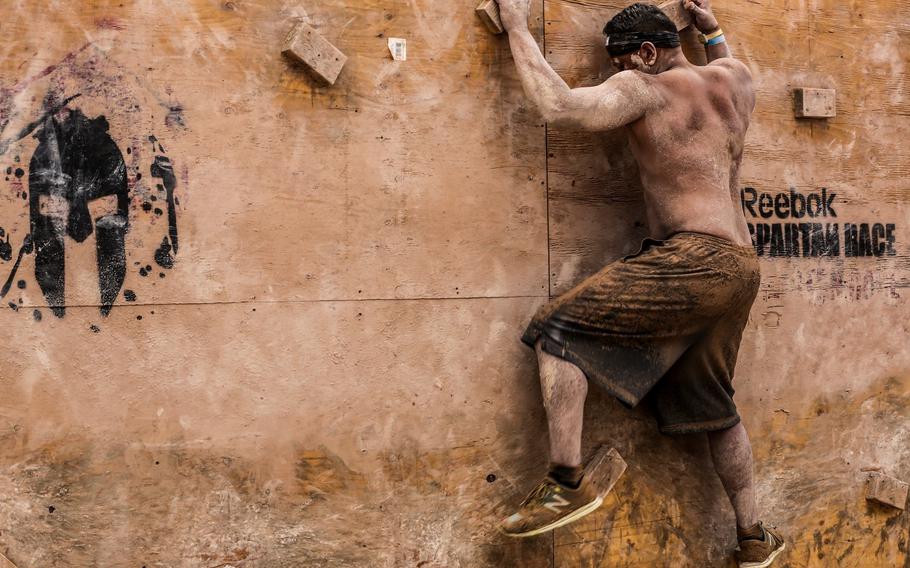 Jacob Martinez, a Marine with the 15th Marine Expeditionary Unit, makes his way across an obstacle during a Spartan Race in Las Vegas, April 5, 2014.