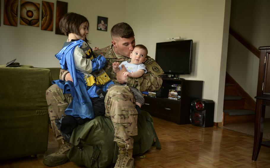 Pfc. Jeremy Monteloene holds his daughter, Jaden, and son, Emrick, after arriving to his home on Rose Barracks, Germany after a seven-month deployment to Afghanistan. Jeremy saw his son for the first time in person as he was deployed during Emick's birth.
