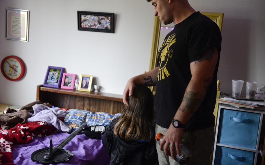 Pfc. Jeremy Monteleone spends time with his daughter Jaden, 4, in their home on Rose Barracks, Germany the day before he deployed to Afghanistan for a planned nine-month tour, Aug. 25, 2013.