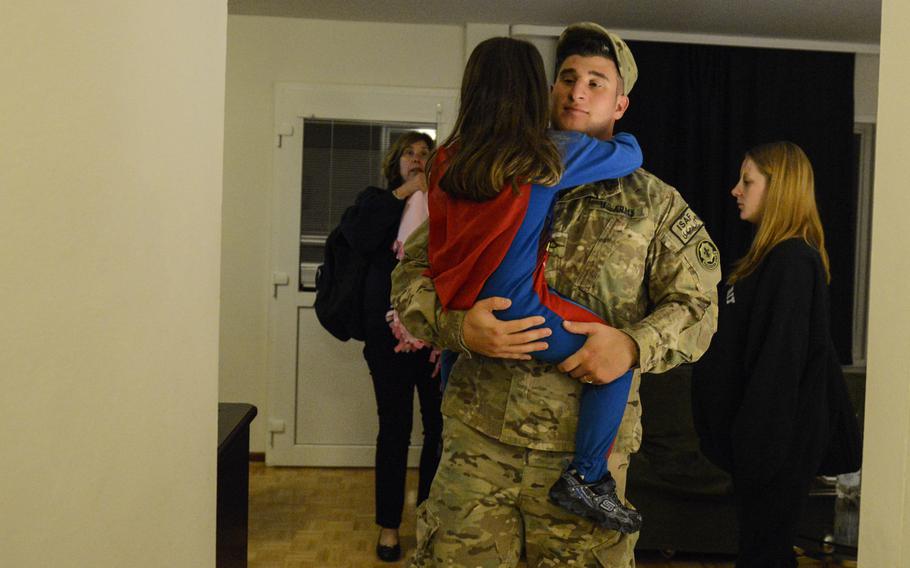 Pfc. Jeremy Monteleone carries his daughter Jaden, 4, to car in the early morning hours of Aug. 26, 2013 as he prepares to leave for a nine-month deployment to Afghanistan. Jeremy's mother, Kate Monteleone, back left, came to Germany to say goodbye to Jeremy and to help out Jeremy's eight-month-pregnant wife Tiana Musson, back right.