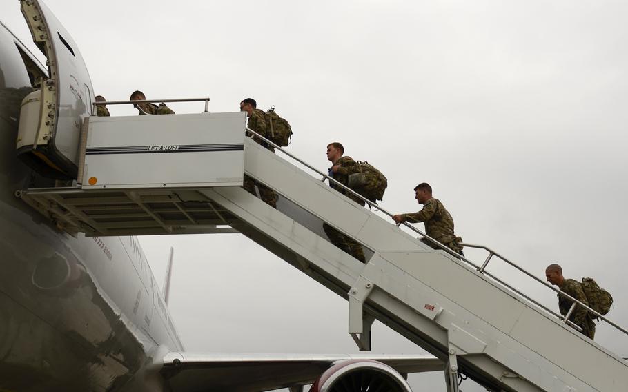 Pfc. Jeremy Monteleone, second from right, boards an airplane from Ramstein Air Base, Germany on his way to Afghanistan for a planned nine-month tour, Aug. 26, 2013.