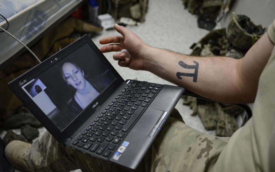 Pfc. Jeremy Monteleone Skypes with his wife, Tiana, from his room at Kandahar Airfield that he shares with two other soldiers, Oct. 13, 2013.