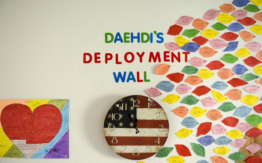 A section of wall at Jeremy Monteleone's house on Rose Barracks, Germany is covered by a collage made by his wife and daughter that counted down the days until his return and listed daily events that happened while he was away.