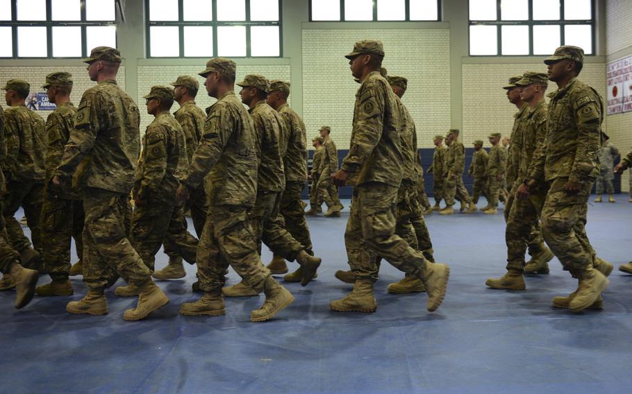Jeremy Monteleone and his unit march into a gym on Rose Barracks, Germany for a brief ceremony after completing a seven-month deployment to Afghanistan, April 8, 2014.