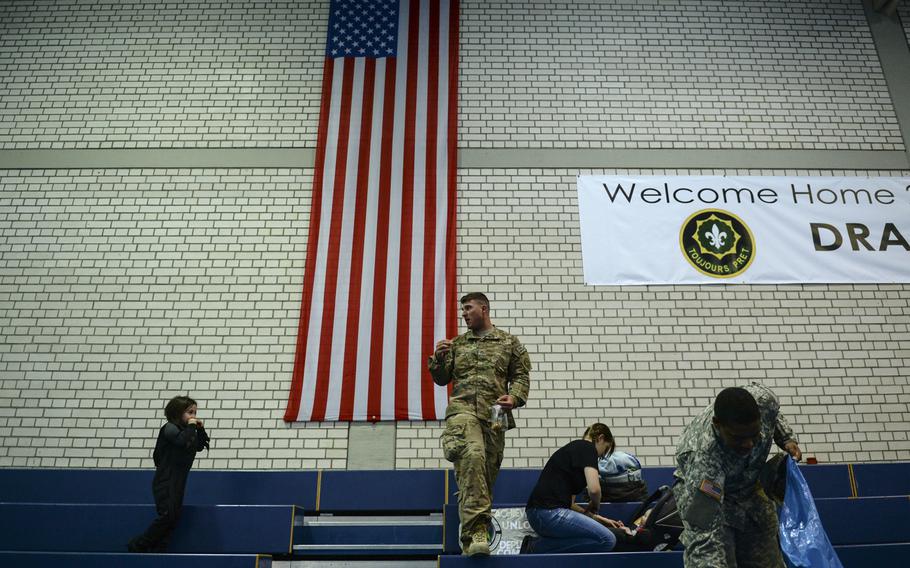 After a seven-month deployment to Afghanistan, Pfc. Jeremy Monteleone and his family are some of the last people to leave the gym just after being reunited at Rose Barracks, Afghanistan, April 8, 2014.