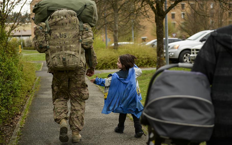 Jaden Monteleone, 5, grabs the hand of her father,Pfc. Jeremy Monteleone, as he carries his deployment bags home after a seven-month deployment, April 8, 2014.