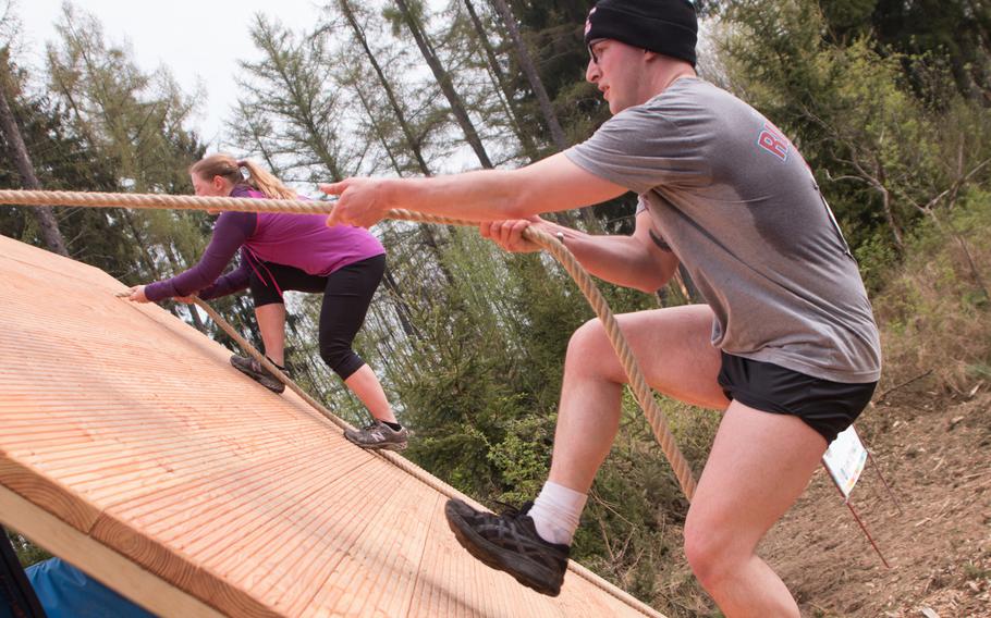 Runners pull themselves over an early obstacle at the 13-kilometer long Grafenwöhr Rugged Terrain Obstacle Course, April 12, 2014.
