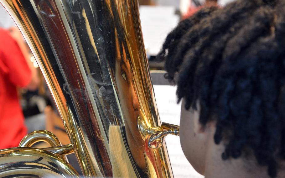 Ramstein's Rakim Cephus is reflected in his tuba as he watches conductor Cecil Wilder at the Department of Defense Dependents Schools-Europe Honors Music Festival, Tuesday, April 15, 2014.