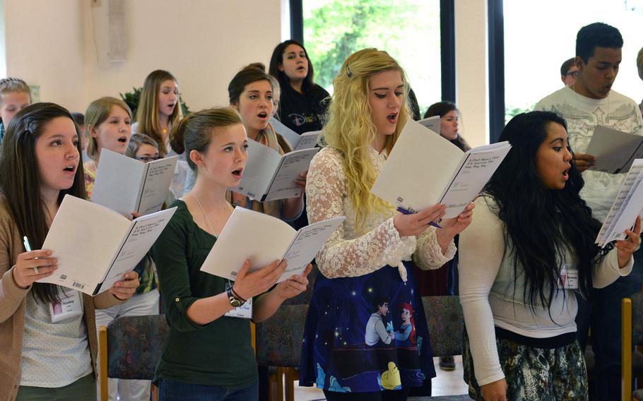 Members of the choir rehearse a tune at the Department of Defense Dependents Schools-Europe Honors Music Festival, Tuesday, April 15, 2014.