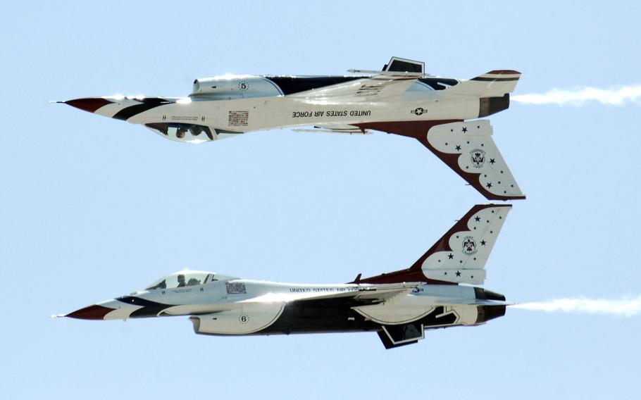 Two U.S. Air Force Thunderbirds perform an inverted formation fly-by during the Thunder and Lightning Over Arizona event at Davis-Monthan Air Force Base, Ariz., on April 13, 2014. In addition to 14 aerial demonstrations, there were more than 40 aircraft static displays during the event.