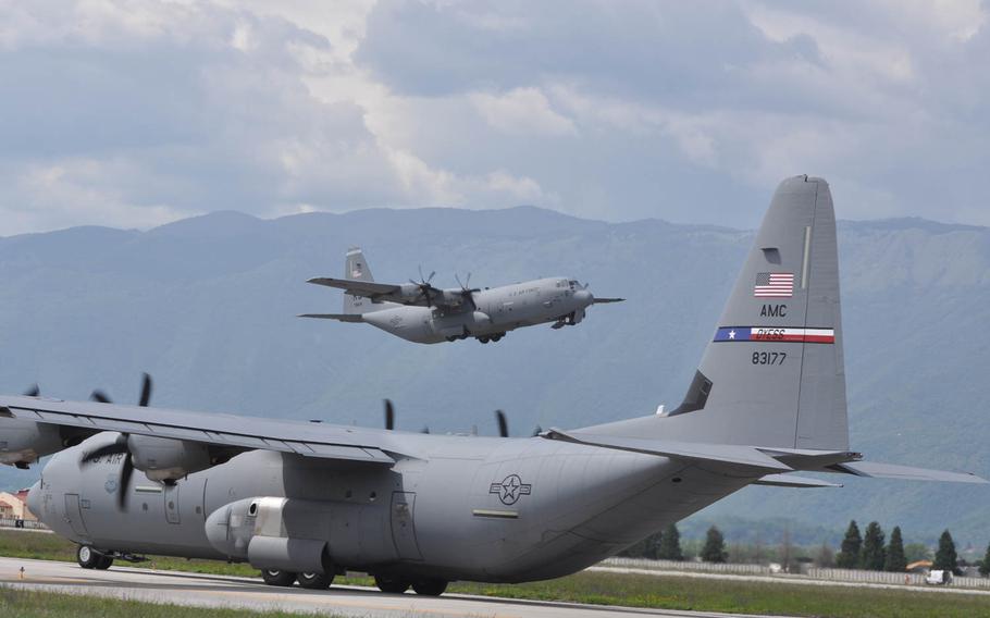 The second of two C-130 cargo planes from Ramstein Air Base, loaded with servicemembers from the 173rd Infantry Brigade Combat Team based in Vicenza, Italy, departs Aviano Air Base for Poland on Wednesday, April 23, 2014. The tail end of one of three C-130's taxis across the runway to take paratroopers from the 173rd to a drop zone for their required 90 day jump.
