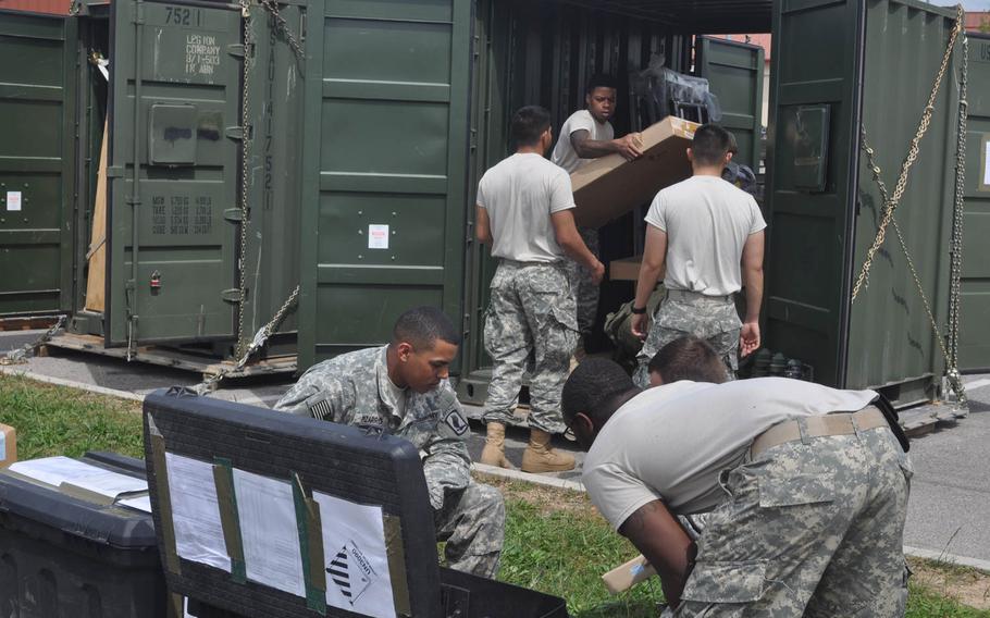Soldiers from the 173rd Infantry Brigade Combat Team sort through some of the equipment that will soon be making its way to to the Baltic States along with soldiers from the unit deploying there. 