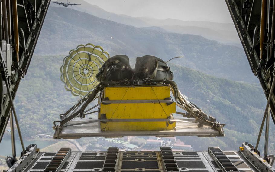 A heavy equipment payload drops from a Yokota Air Base C-130H Hercules over the Republic of Korea during Exercise Max Thunder on Friday, April 18, 2014. Raymond Geoffroy/U.S. Air Force