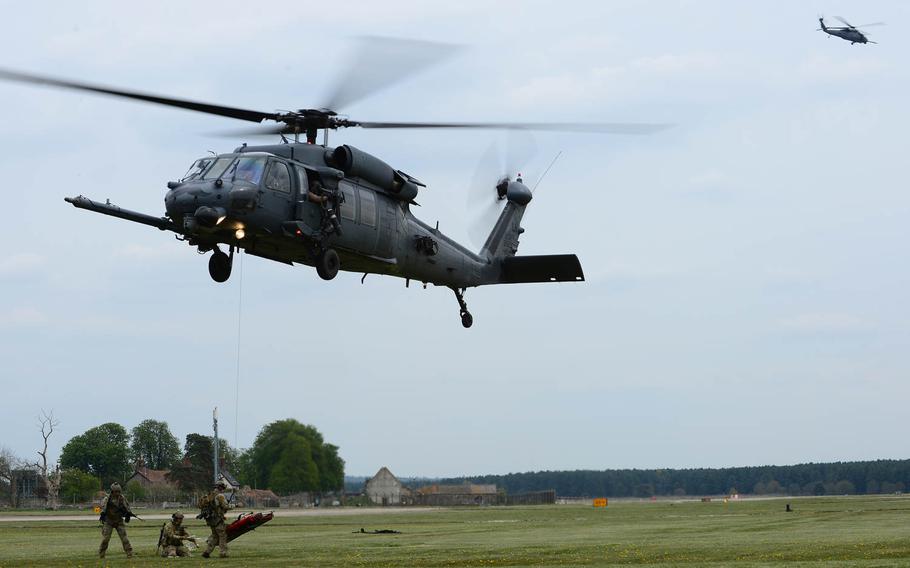 A 56th Rescue Squadron pararescue team straps in a mock crash scene victim before hoisting the patient up into an HH-60G Pave Hawk during a combat search and rescue exercise at Royal Air Force Lakenheath, England, on Thursday, April 17, 2014. The rescue mission scenario included pararescue and security forces teams recovering a victim injured by an improvised explosive device. 