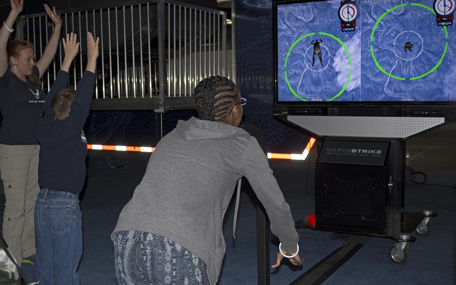 Two kids practice parachuting from an airplane on a U.S. Air Force simulation at the USA Science and Engineering Festival on April 25, 2014 in Washington, D.C.