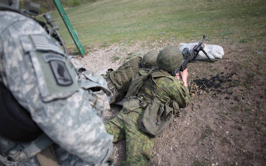 Lithuanian soldiers fire an American M240 machine gun during bilateral training between American troops of the 173rd Infantry Brigade Combat Team and Lithuania's Iron Wolf Brigade.