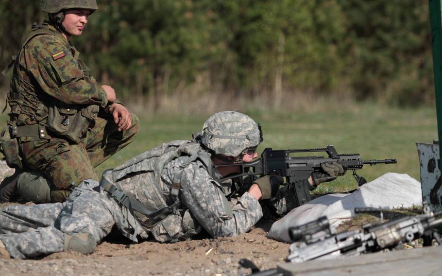 An American soldier with the 173rd Infantry Brigade Combat Team fires a Lithuanian G36 rifle Tuesday, April 29, 2014, at Rukla Training Area in Lithuania. A company of soldiers from the Vicenza, Italy- based 173rd arrived here Saturday to conduct training with the Lithuanians, part of a deployment of 600 173rd paratroops meant to reassure NATO allies concerned about Russian aggression.