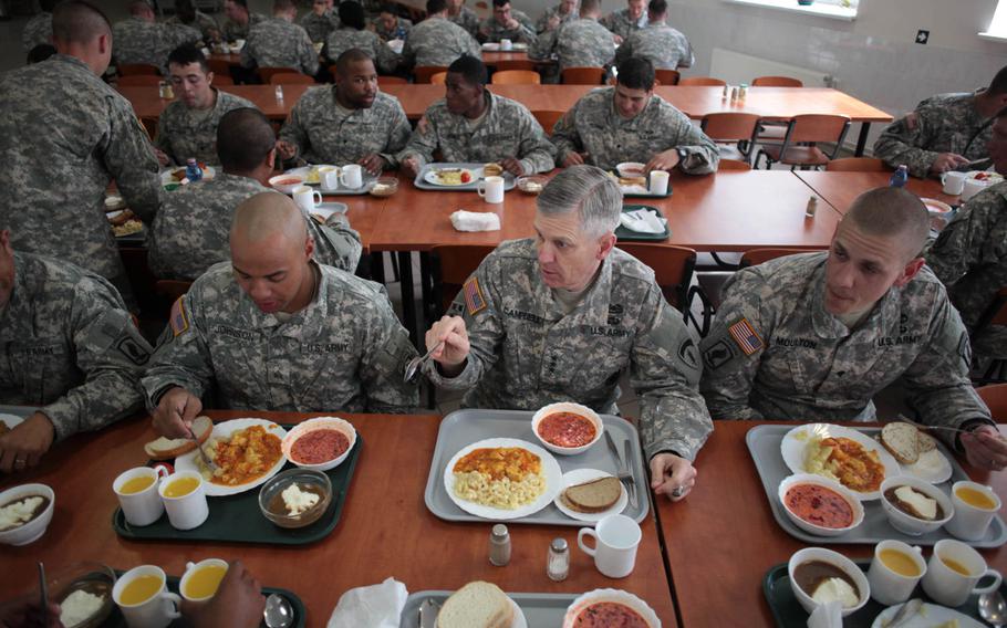 Lt. Gen. Donald Campbell Jr., commander of U.S. Army Europe, center, eats lunch with soldiers of the 173rd Infantry Brigade Combat Team in Adazi, Latvia, where a company of American soldiers deployed last week to reassure the NATO ally of the U.S. commitment to its security in the wake of Russia's actions in Ukraine.