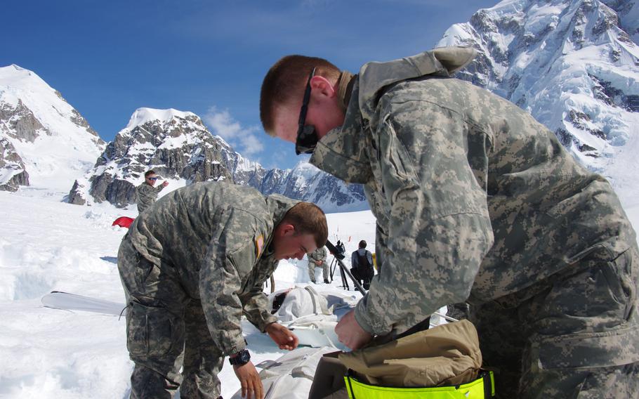Soldiers from Team 1, assigned to the 1st Stryker Brigade Combat Team, 25th Infantry Division, ready equipment at the Kahiltna Glacier Base Camp, Alaska, in late May. From this base camp at 7,600 feet, the soldiers are climbing for several weeks in an attempt to reach Mount McKinley's peak at 20,320 feet.