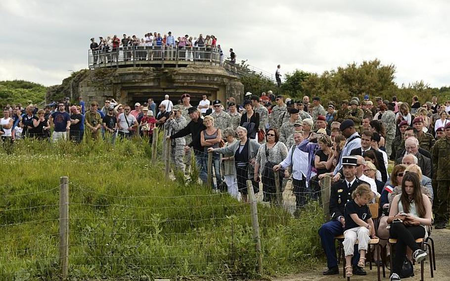 A crowd at the Ranger Regiment Memorial watches the 70th anniversary D-Day commemoration June 7, 2014, honoring the Ranger Regiment's achievements at Pointe du Hoc, France during World War II.