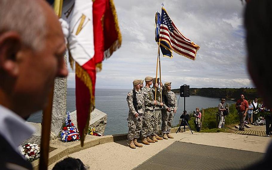An honor guard made up of soldiers with the Ranger Regiment presents the colors during the 70th anniversary D-Day commemoration at the Ranger Regiment Memorial at Pointe du Hoc, France, Saturday, June 7, 2014.