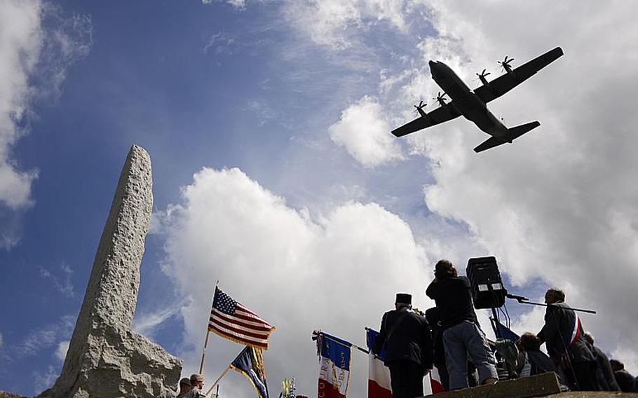 A U.S. Air Force C-130 performs a flyby during the 70th anniversary D-Day commemoration honoring the Rangers' achievements at Pointe du Hoc, France, Saturday, June 7, 2014.