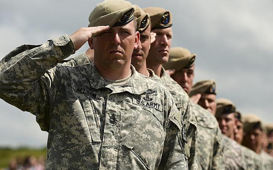 Soldiers with the Ranger Regiment salute during the 70th anniversary D-Day commemoration honoring the regiment's achievements at Pointe du Hoc, France, Saturday, June 7, 2014.