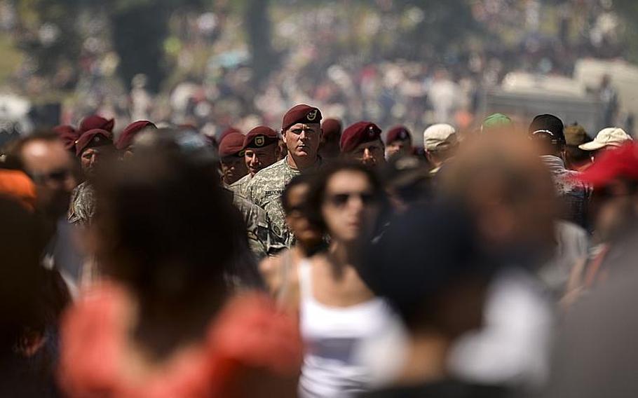 Soldiers with the 173rd Airborne Brigade march to the "Iron Mike" monument for a ceremony in Cauquigny, France, after a parachute drop commemorating the 70th anniversary of D-Day, Sunday, June 8, 2014.