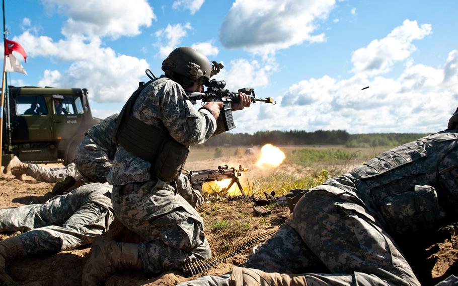 Soldiers from Troop C. 2nd Squadron, 104th Cavalry Regiment of the Pennsylvania National Guard open fire on "opposing forces" in a battle simulation during Saber Strike 2014 at Rukla Training Area, Lithuania, June 16, 2014. Saber Strike 2014 is a joint, multi-national military exercise running June 9- 20. The exercise spans multiple locations in Lithuania, Latvia and Estonia, and involves approximately 4,700 personnel from 10 countries.