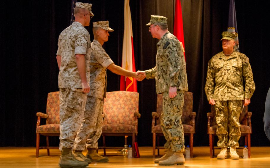U.S. 5th Fleet Commander Vice Adm. John Miller, right, shakes hands with Marine Brig. Gen. Carl Mundy III as the latter assumes command of Commander, Task Force 51, on Sunday, Sept. 14, 2014. Mundy will oversee the amphibious forces operating in the U.S. 5th Fleet area of responsibility.