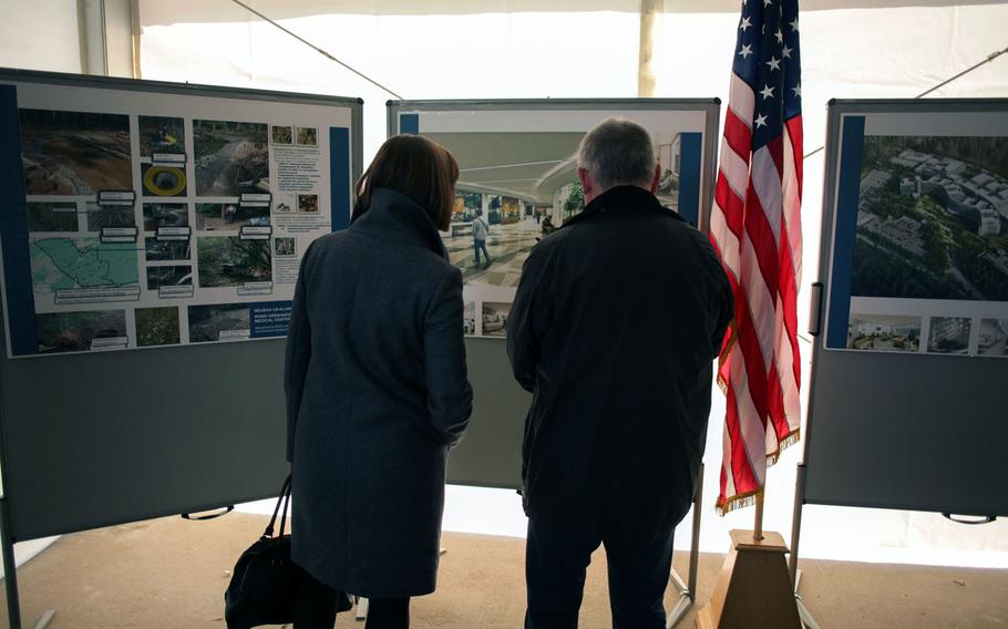 Attendees at the ground breaking for a new U.S. military hospital in Weilerbach, Germany, Friday, Oct. 24, 2014, look at an artist's rendering of the new facility, which is expected to open in 2022.