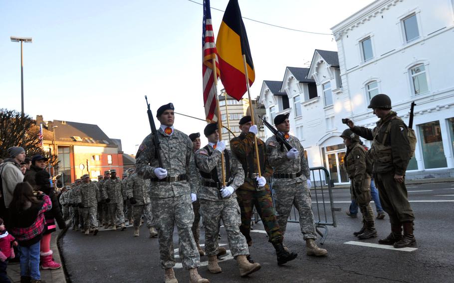 A color guard of Belgian and American soldiers marches in a parade on Saturday, Dec. 14, 2013, in Bastogne, Belgium. The parade was one of several events designed to commemorate the successful defense of the town by Allied forces in World War II.