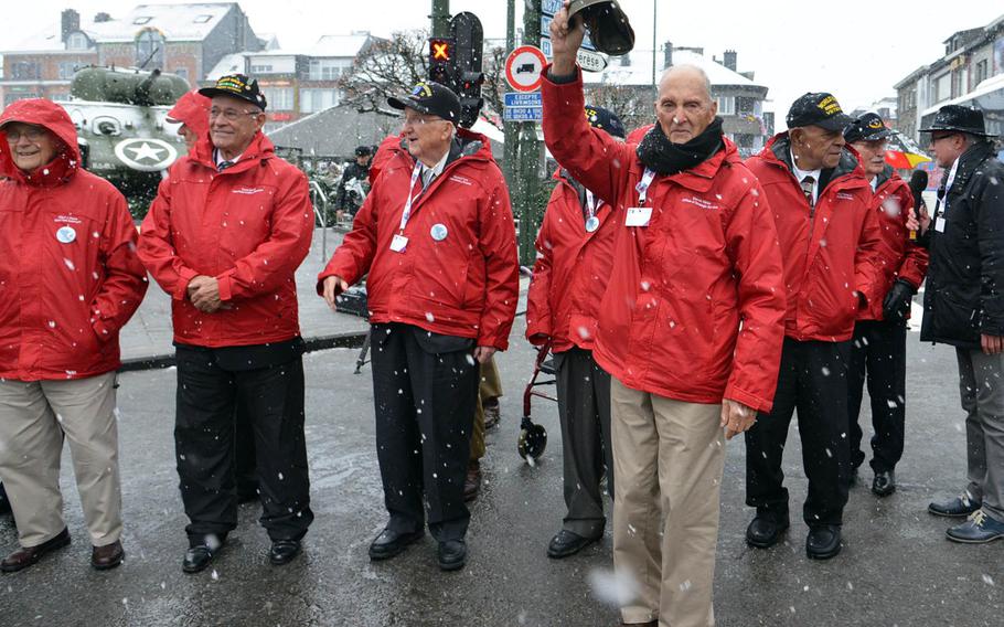 World War II veteran Steven Weiss waves to the crowd as he and other veterans prepare to attend a wreath-laying ceremony in Bastogne, Belgium, Dec. 13, 2014, that was part of commemorations marking the 70th anniversary of the Battle of the Bulge.