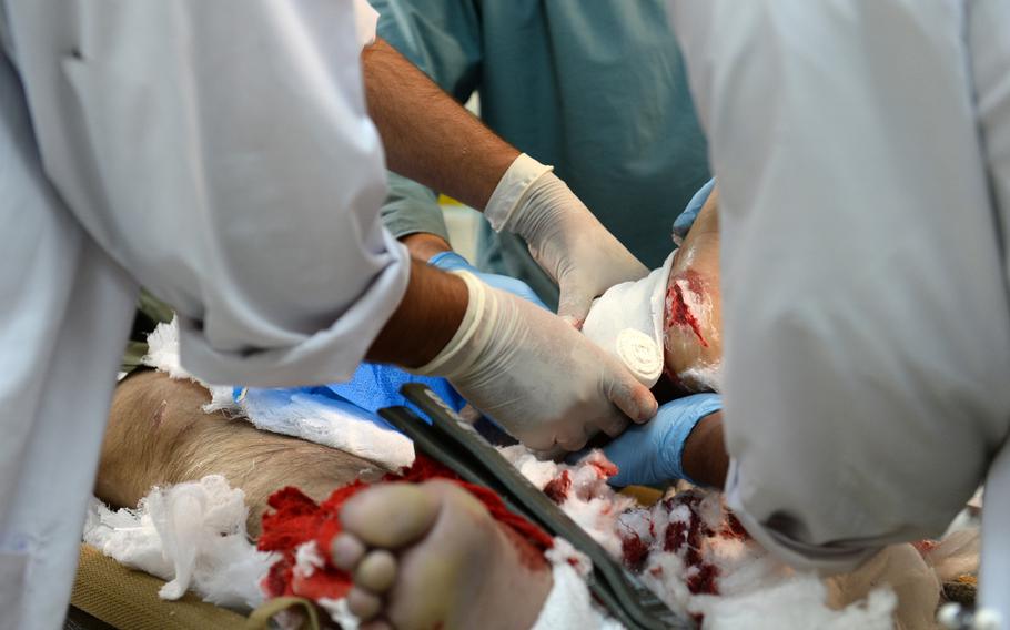 Medical staff at the Kandahar Regional Military Hospital operate on the legs of an Afghan National Army soldier injured by a roadside bomb on Jan. 6, 2015. Doctors say they have advanced resources to help injured security forces and civilians, but long evacuation times often make providing that care more difficult.