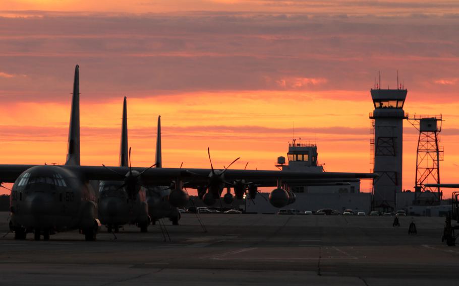 Several KC-130J Super Hercules aerial refueler aircraft with Marine Aerial Refueler Transport Squadron 252 sit on the flight line at Marine Corps Air Station Cherry Point, N.C., Jan. 5, 2015, as the Air Traffic Control Tower rises in the background.