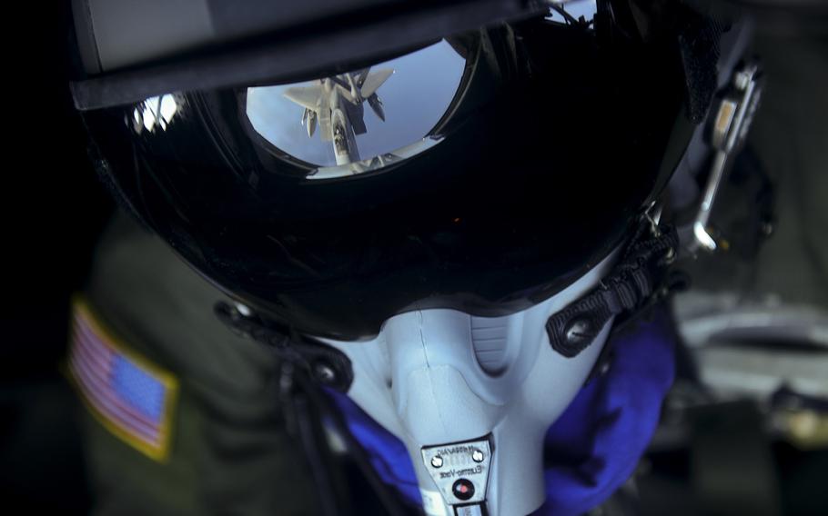 Senior Airman Charlton Hampton, 909th Air Refueling Squadron boom operator, refuels a U.S. Air Force F-15C Eagle from Kadena Air Base, Japan, from a KC-135 Stratotanker near Okinawa, Japan, Dec. 23, 2014.