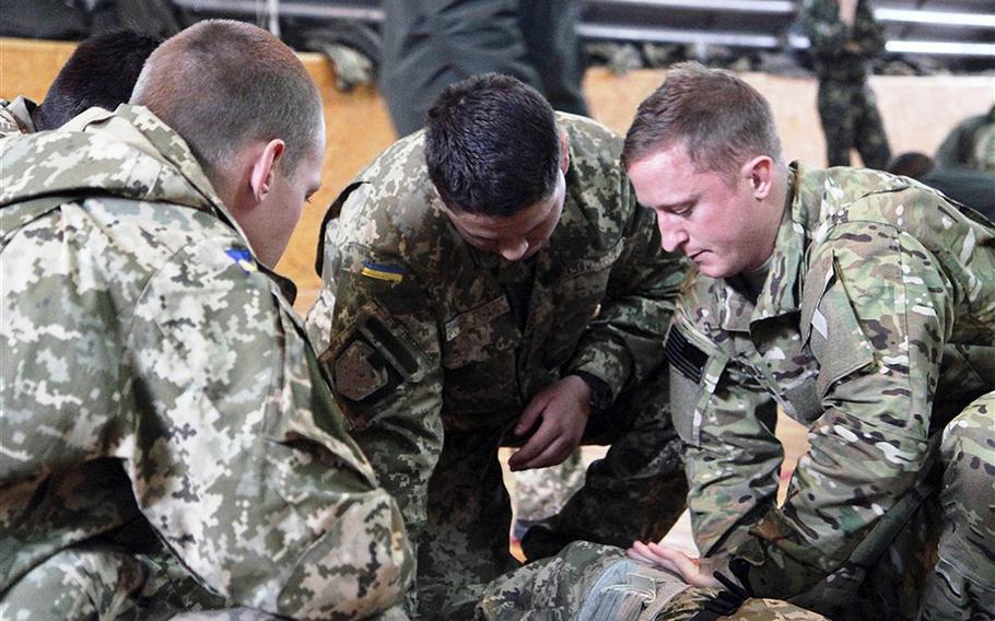 A U.S. Air Force Special Operations Medical Officer from U.S. Special Operations Command Europe demonstrates for Ukranian soldiers how to apply a tourniquet and bandage a wound on Tuesday, November 18, 2014 in Khmelnytskyi, Ukraine. SOCEUR deployed a medical team to Western Ukraine to coach and mentor Ukrainian Ministry of Defense personnel on basic battlefield medical procedures. In the spring, U.S. Army Europe will send a team of advisers into western Ukraine to help train troops according to USARUER commander Lt. Gen. Ben Hodges.