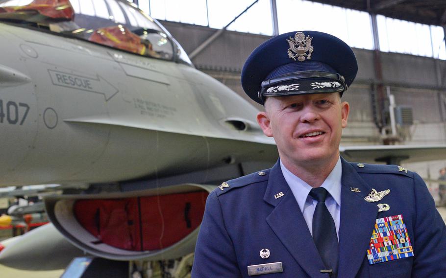 The new commander of the 52nd Fighter Wing, Col. Joseph McFall, talks to the media after his assumption of command ceremony at Spangdahlem Air Base, Germany, Thursday, Feb. 5, 2015. In the background is one of the wing's F-16 Fighting Falcon.
