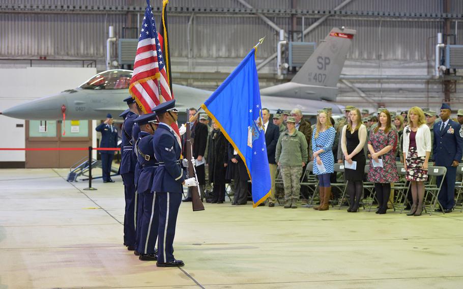 The 52nd Fighter Wing honor guard presents the colors at the beginning of the assumption of command ceremony for Col. Joseph McFall at Spangdahlem Air Base, Germany, Thursday, Feb. 5, 2015. McFall took command of the wing at the ceremony
