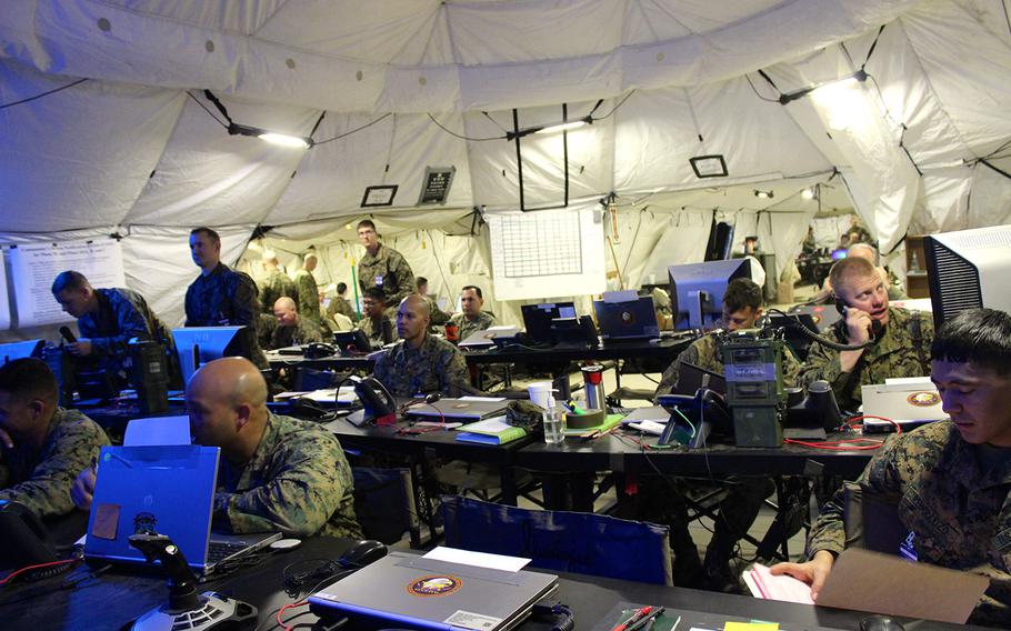 Marines in the combat operations center plan an attack on an enemy force occupying a partner nation during a training exercise at Camp Pendleton, Calif. The exercise, which simulates the deployment of 50,000 troops, is the first of its scale in 12 years.